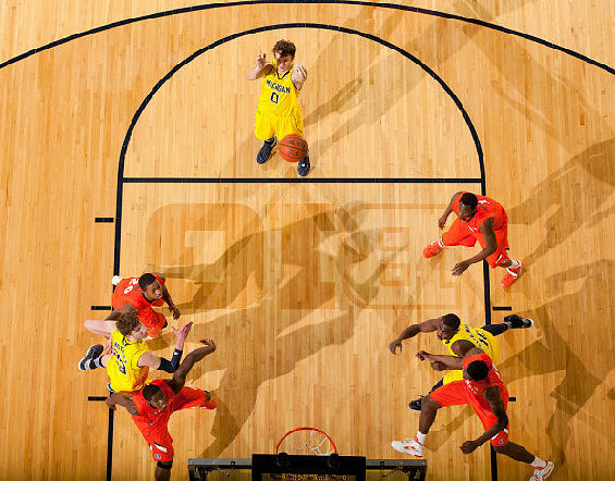 Evan Smotrycz (23), Zack Novak (0), and Tim Hardaway Jr. (10)
