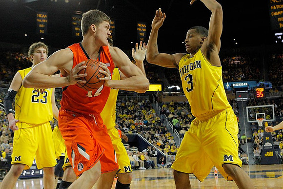 Evan Smotrycz (23), Stu Douglass (1), and Trey Burke (3)