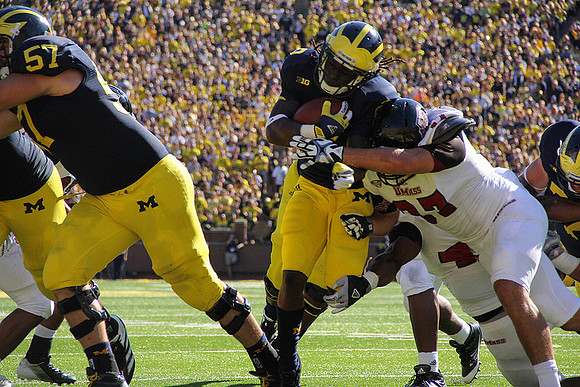 Elliott Mealer (57), Denard Robinson (16), and Taylor Lewan (77)
