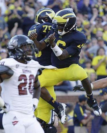 Michael Schofield (75) and Denard Robinson (16)