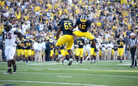 Patrick Omameh (65) and Denard Robinson (16)