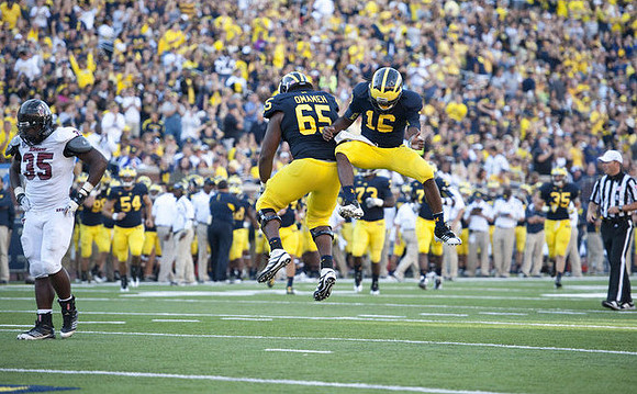 Patrick Omameh (65) and Denard Robinson (16)