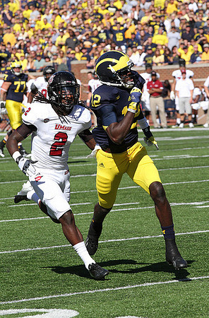 Taylor Lewan (77) and Devin Gardner (12)