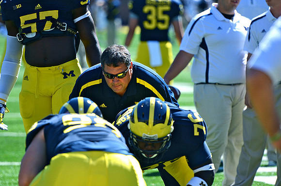 Frank Clark (57), Brady Hoke, Quinton Washington (76), and Joe Bolden (35)