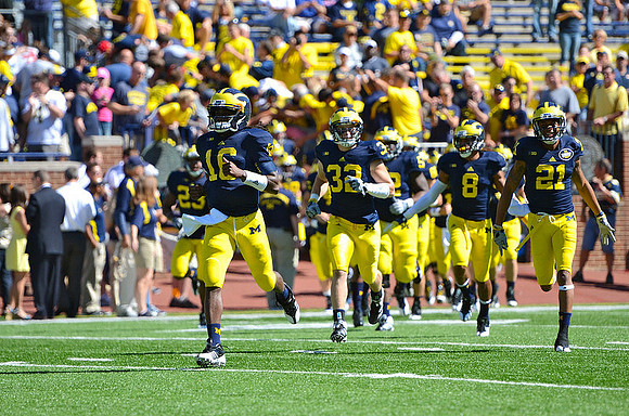 Floyd Simmons (23), Denard Robinson (16), Jordan Kovacs (32), Ricky Barnum (52), Russell Bellomy (8), and Roy Roundtree (21)