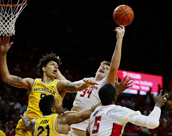 D.J. Wilson (5) and Zak Irvin (21)