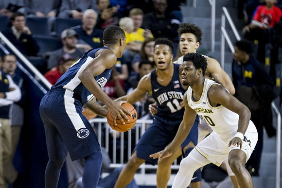 D.J. Wilson (5) and Derrick Walton Jr. (10)