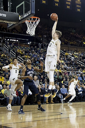 Moritz Wagner (13), D.J. Wilson (5), and Zak Irvin (21)