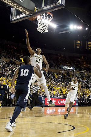 Zak Irvin (21) and Derrick Walton Jr. (10)