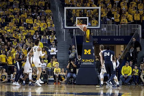 D.J. Wilson (5), Derrick Walton Jr. (10), and Mark Donnal (34)