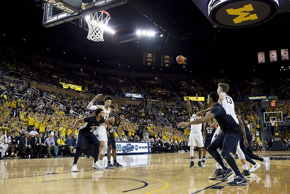 D.J. Wilson (5), Moritz Wagner (13), and Derrick Walton Jr. (10)