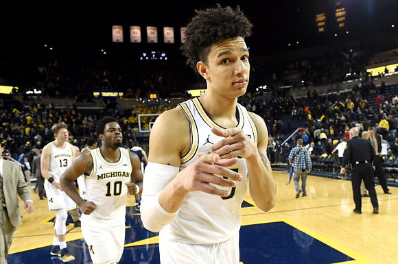 Moritz Wagner (13), Derrick Walton Jr. (10), and D.J. Wilson (5)