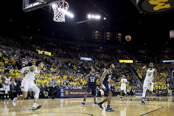 D.J. Wilson (5), Muhammad-Ali Abdur-Rahkman (12), and Derrick Walton Jr. (10)