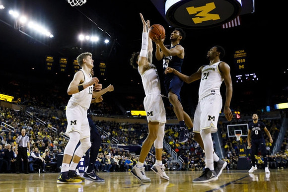 Moritz Wagner (13), D.J. Wilson (5), and Zak Irvin (21)