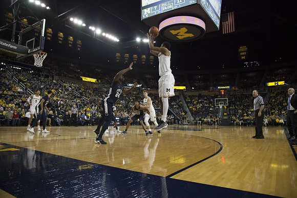D.J. Wilson (5), Moritz Wagner (13), and Zak Irvin (21)