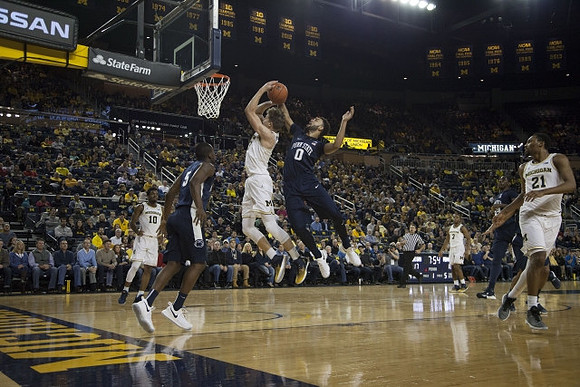 Moritz Wagner (13), Derrick Walton Jr. (10), Zak Irvin (21), and Xavier Simpson (3)