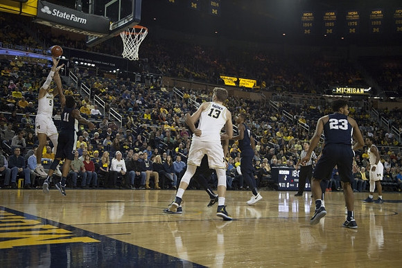 D.J. Wilson (5), Moritz Wagner (13), and Derrick Walton Jr. (10)