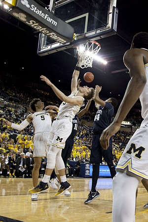 D.J. Wilson (5) and Moritz Wagner (13)