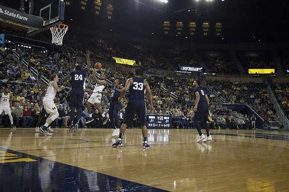 Zak Irvin (21), Mark Donnal (34), and Xavier Simpson (3)
