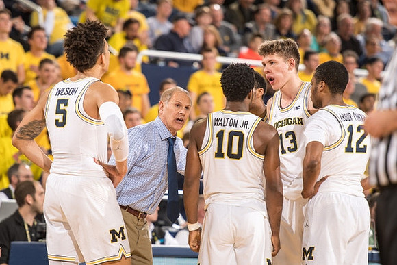D.J. Wilson (5), John Beilein, Derrick Walton Jr. (10), Moritz Wagner (13), and Muhammad-Ali Abdur-Rahkman (12)