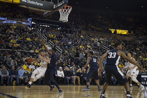 Moritz Wagner (13) and D.J. Wilson (5)