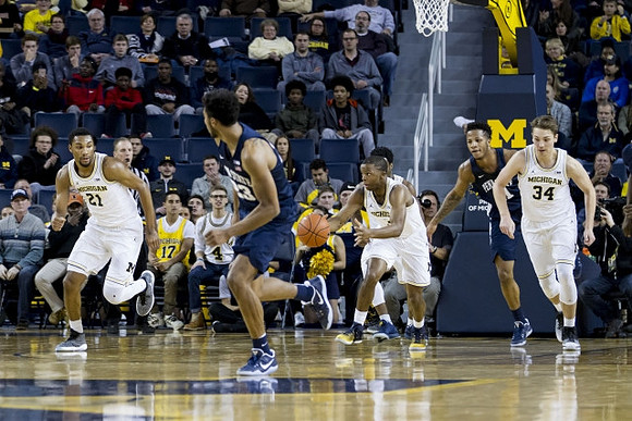 Zak Irvin (21), Moritz Wagner (13), and Mark Donnal (34)