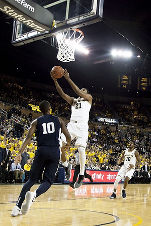 Zak Irvin (21) and Derrick Walton Jr. (10)