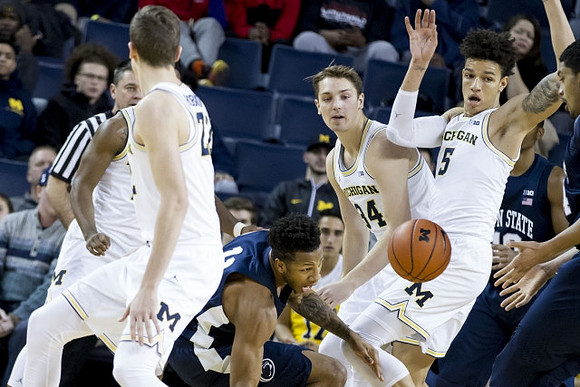 Duncan Robinson (22), Mark Donnal (34), and D.J. Wilson (5)