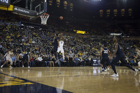 D.J. Wilson (5) and Zak Irvin (21)