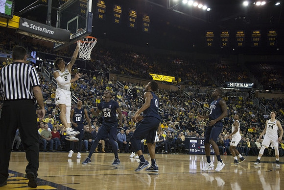 D.J. Wilson (5), Xavier Simpson (3), and Mark Donnal (34)
