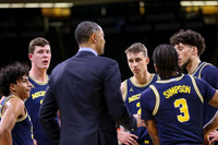 Eli Brooks (55), Jon Teske (15), Juwan Howard, Franz Wagner (21), Zavier Simpson (3), and Brandon Johns Jr. (23)