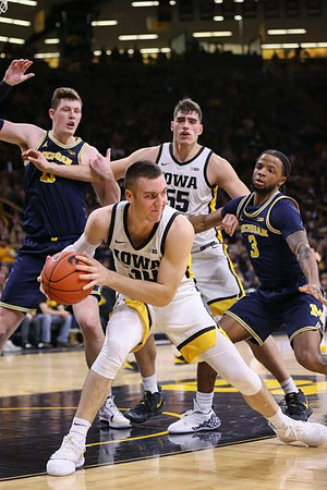 Jon Teske (15) and Zavier Simpson (3)