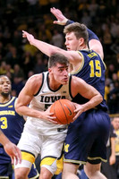 Zavier Simpson (3) and Jon Teske (15)