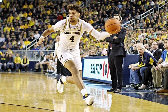 Isaiah Livers (4) and Minnesota Head Coach Richard Pitino