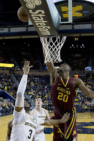 Zavier Simpson (3) and Jon Teske (15)