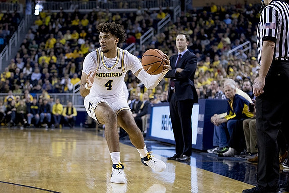 Isaiah Livers (4) and Minnesota Head Coach Richard Pitino