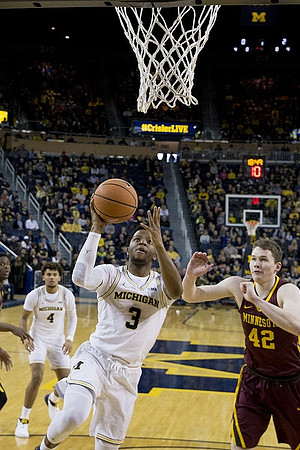 Zavier Simpson (3) and Isaiah Livers (4)
