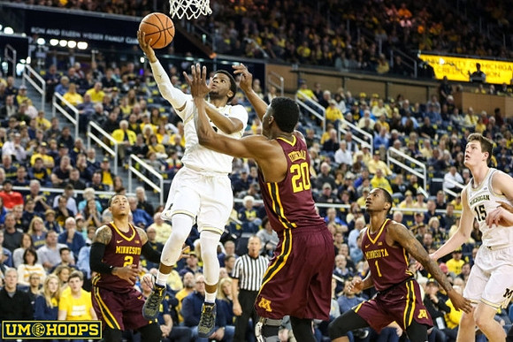 Zavier Simpson (3) and Jon Teske (15)