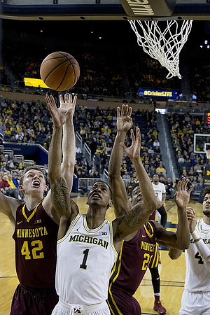 Charles Matthews (1), Zavier Simpson (3), and Isaiah Livers (4)
