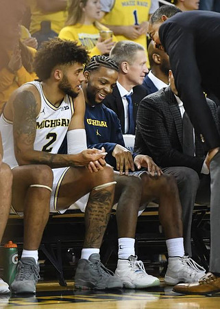 Isaiah Livers (2), Zavier Simpson (3), and Juwan Howard
