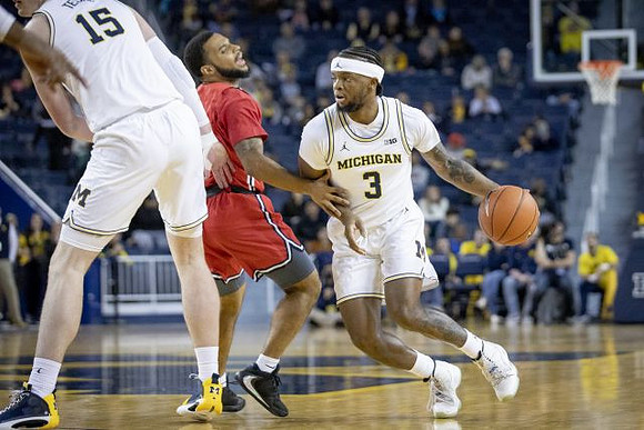 Jon Teske (15) and Zavier Simpson (3)