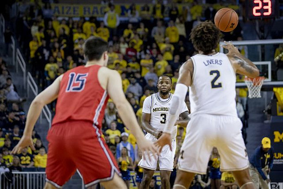 Zavier Simpson (3) and Isaiah Livers (2)