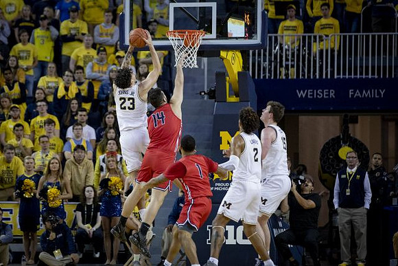 Brandon Johns Jr. (23), Isaiah Livers (2), and Jon Teske (15)