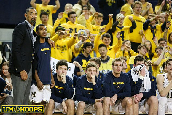 Juwan Howard, Rico Ozuna-Harrison (14), and Michigan Team
