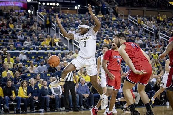 Zavier Simpson (3) and Brandon Johns Jr. (23)