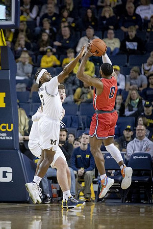 Zavier Simpson (3) and Jon Teske (15)