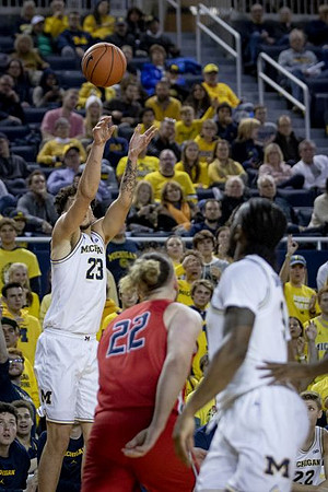 Brandon Johns Jr. (23) and Zavier Simpson (3)