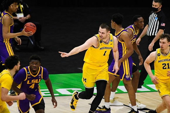 Brandon Johns Jr. (23), Hunter Dickinson (1), and Franz Wagner (21)
