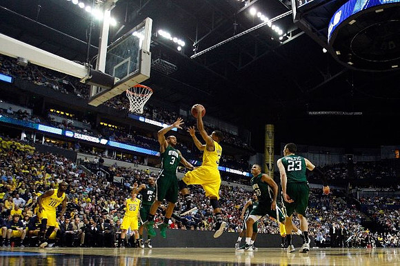 Tim Hardaway Jr. (10), Evan Smotrycz (23), and Trey Burke (3)