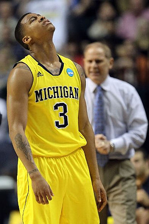 Trey Burke (3) and John Beilein